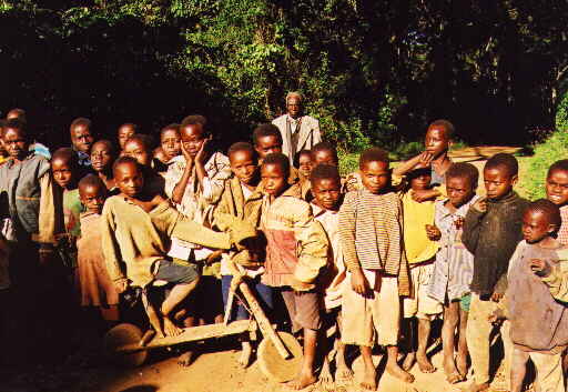 a group of s are posing together in front of a vehicle