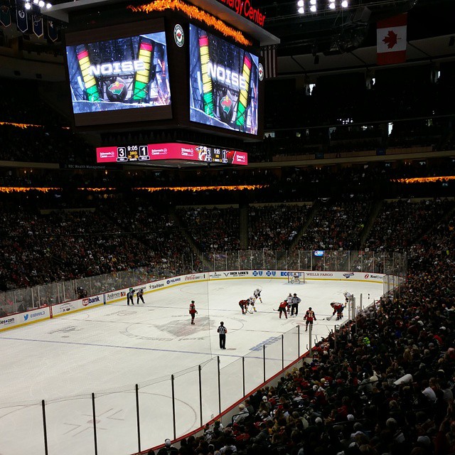 an arena with a group of people watching a hockey game