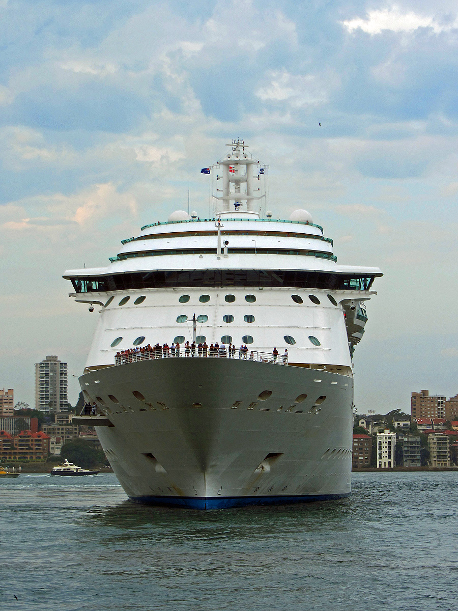 several people are standing on the front of the cruise ship