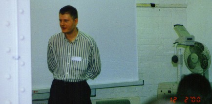 a man giving a lecture to a classroom of students