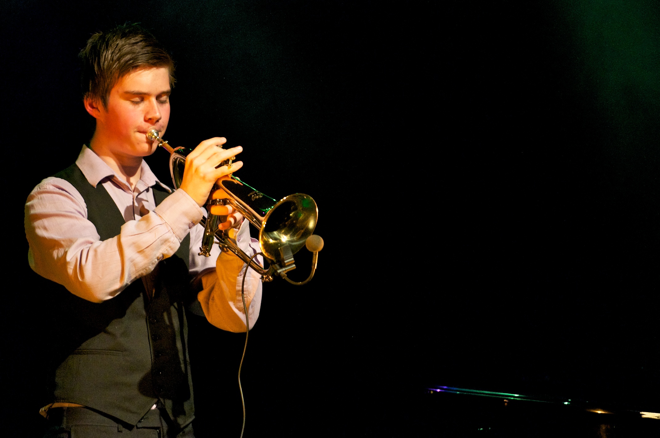 a man playing a trumpet on a stage