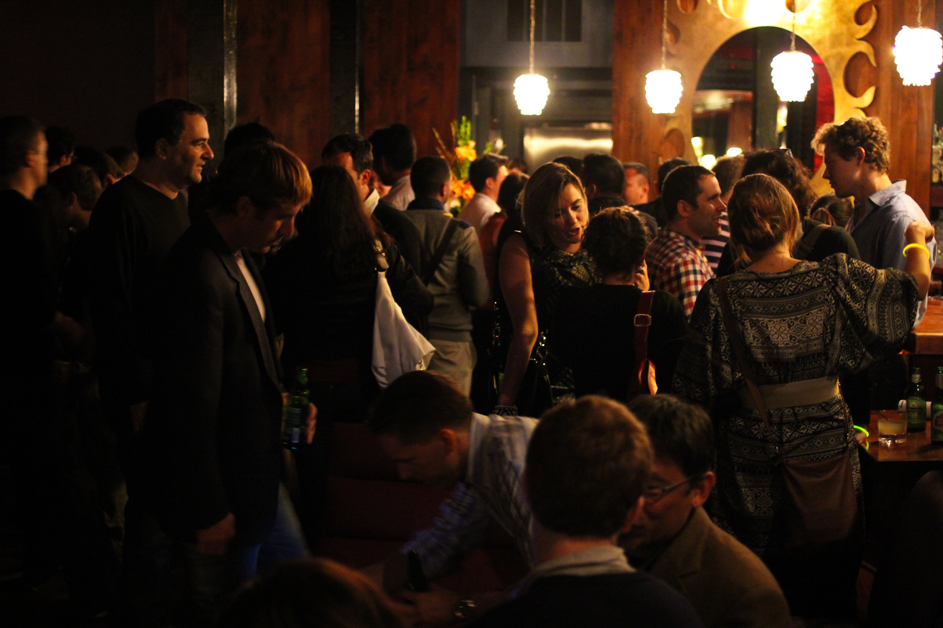 a large group of people gather in the bar area