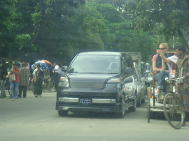 people getting their bikes in front of the van