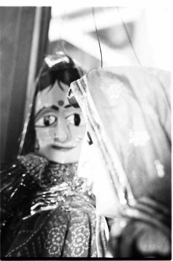 a doll wearing a sari with a glass nose and long veil