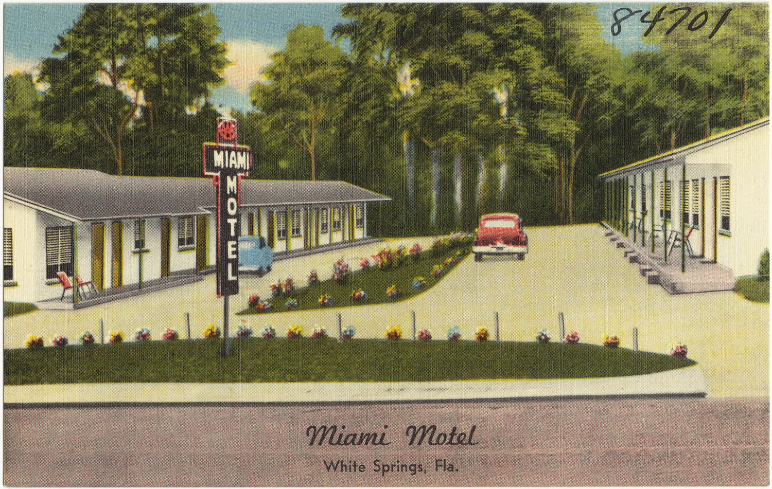 the motel is located across from a lot of trees