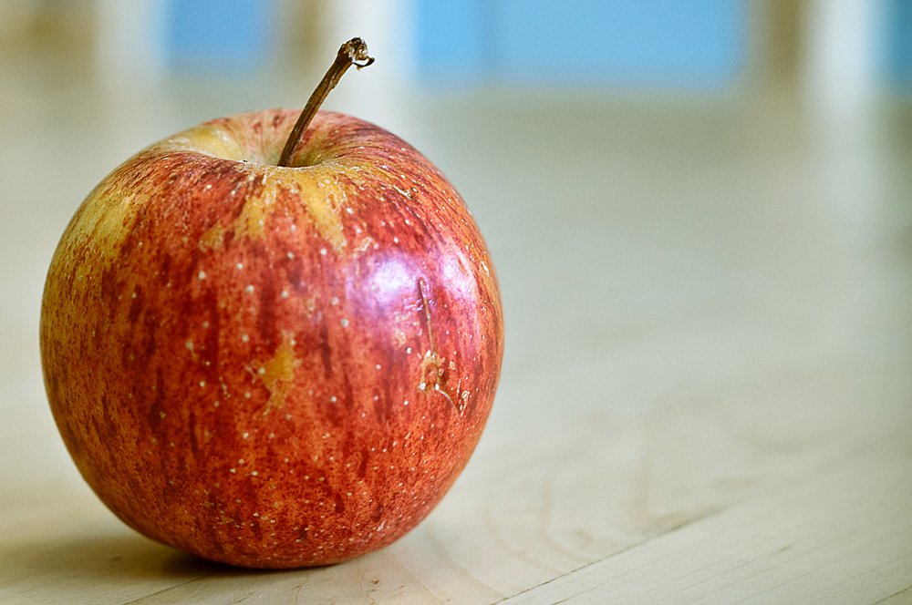 an apple sitting on top of a wooden table