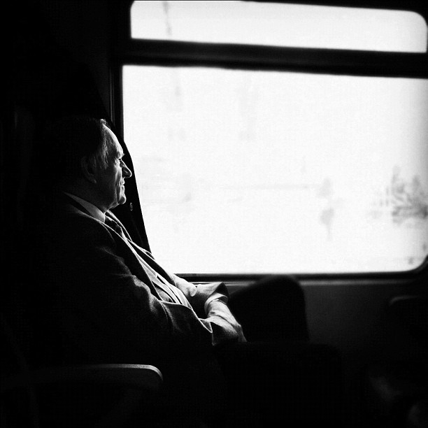 a man sitting in a seat next to a window