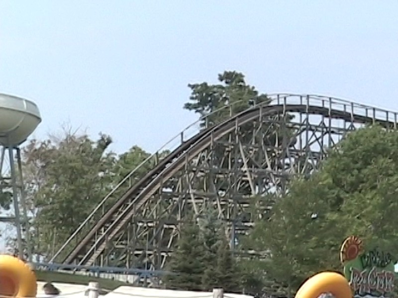 a roller coaster going down the hill in a amut park