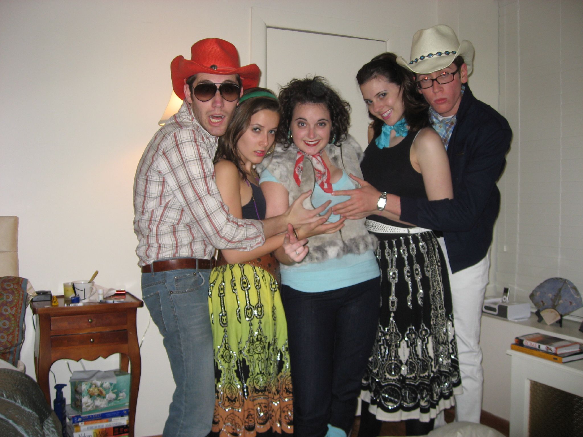 four people posing for a picture in a room