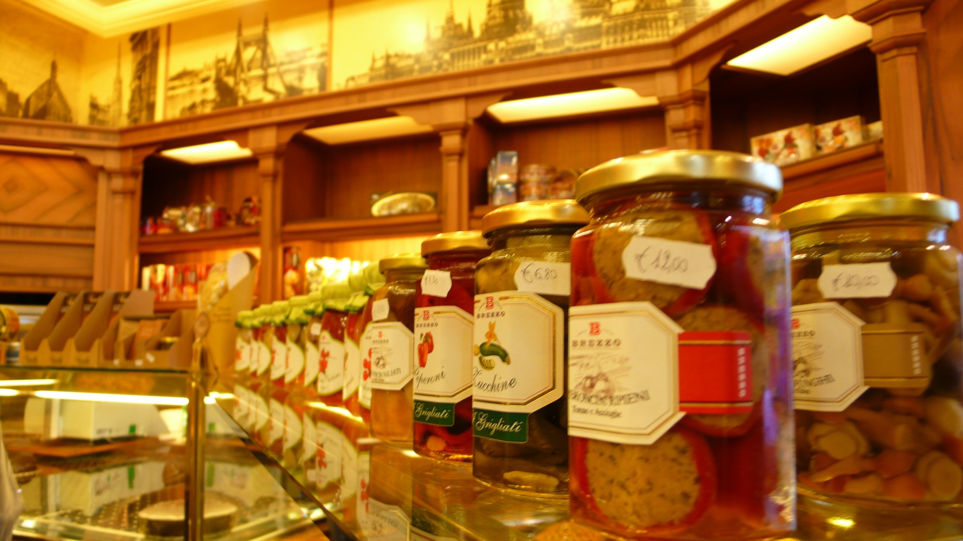many jars with labels are stacked on display