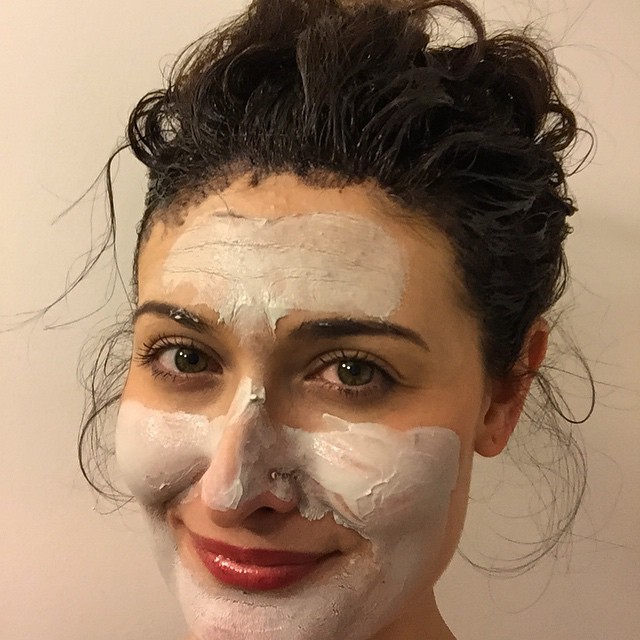 woman with white face mask on looking in camera
