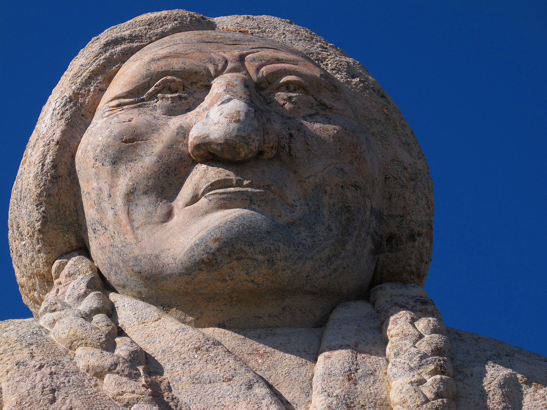 an ornate statue that has his face pressed back