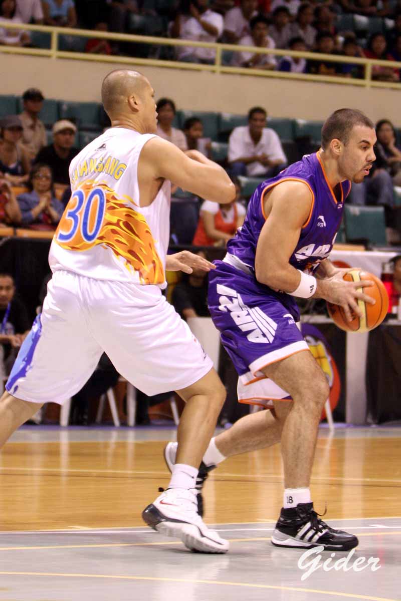 two basketball players in purple and white play during the game