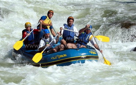 people in blue raft rafts white water rapids