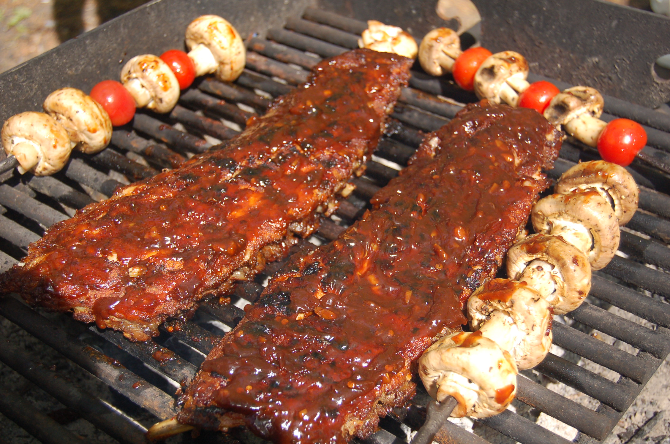 two pieces of barbecue ribs covered in bbq sauce