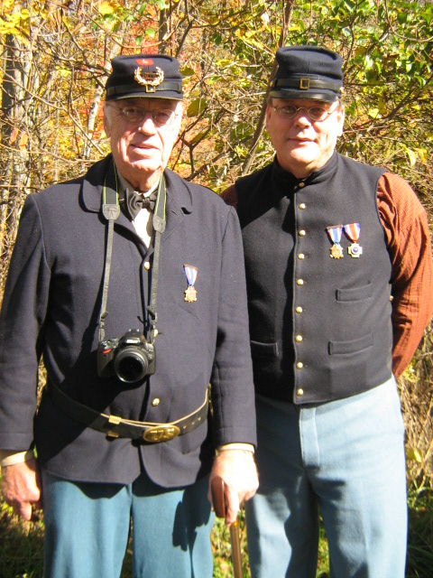 two old people in blue military uniforms posing for a po