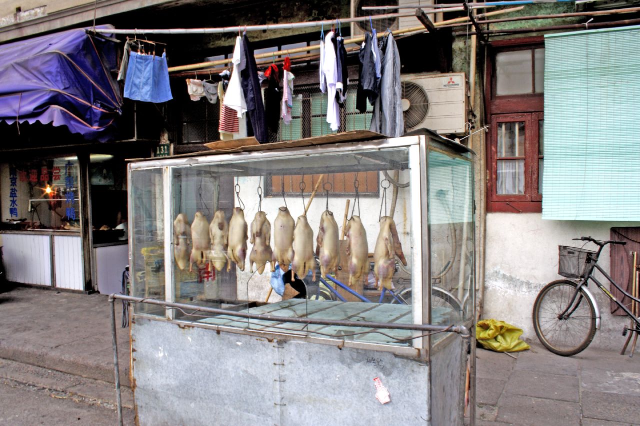 an outside view of meat stand selling several meats