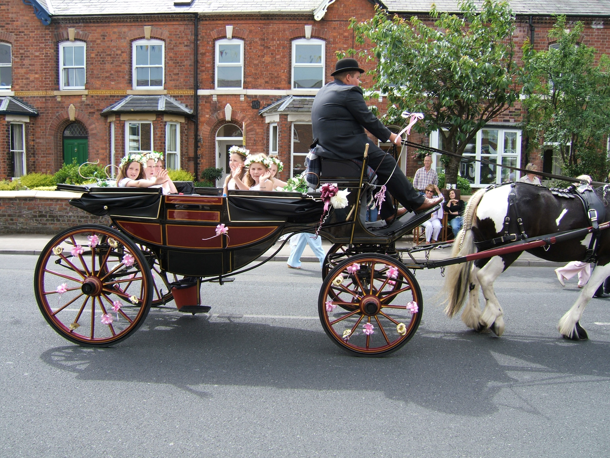 people are in the carriage pulled by a horse