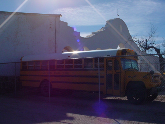 a school bus parked near a building on the side of the road