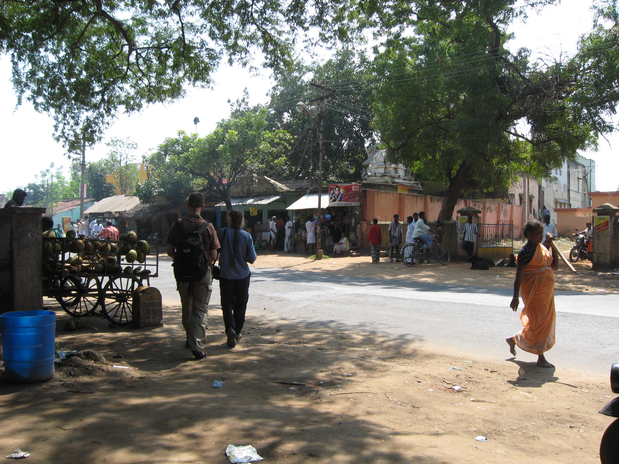 some people walking down the street with many objects