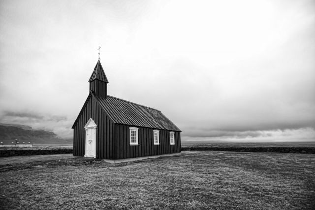 a church standing alone in an empty field