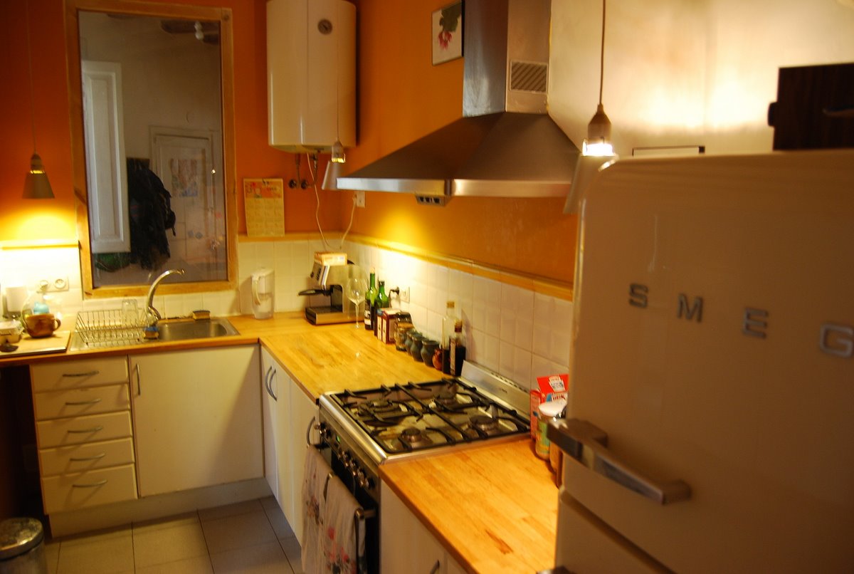 a refrigerator and stove sitting inside of a kitchen