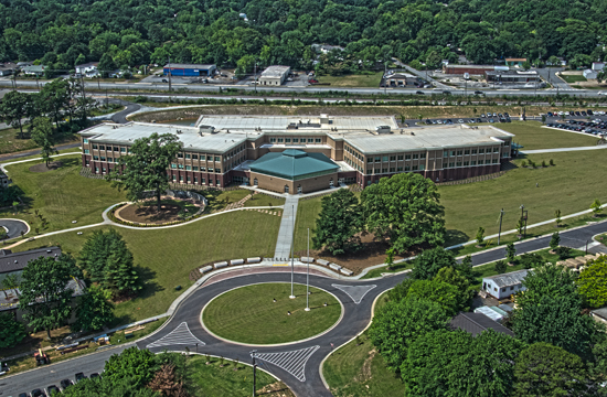 an aerial s of a building surrounded by many trees