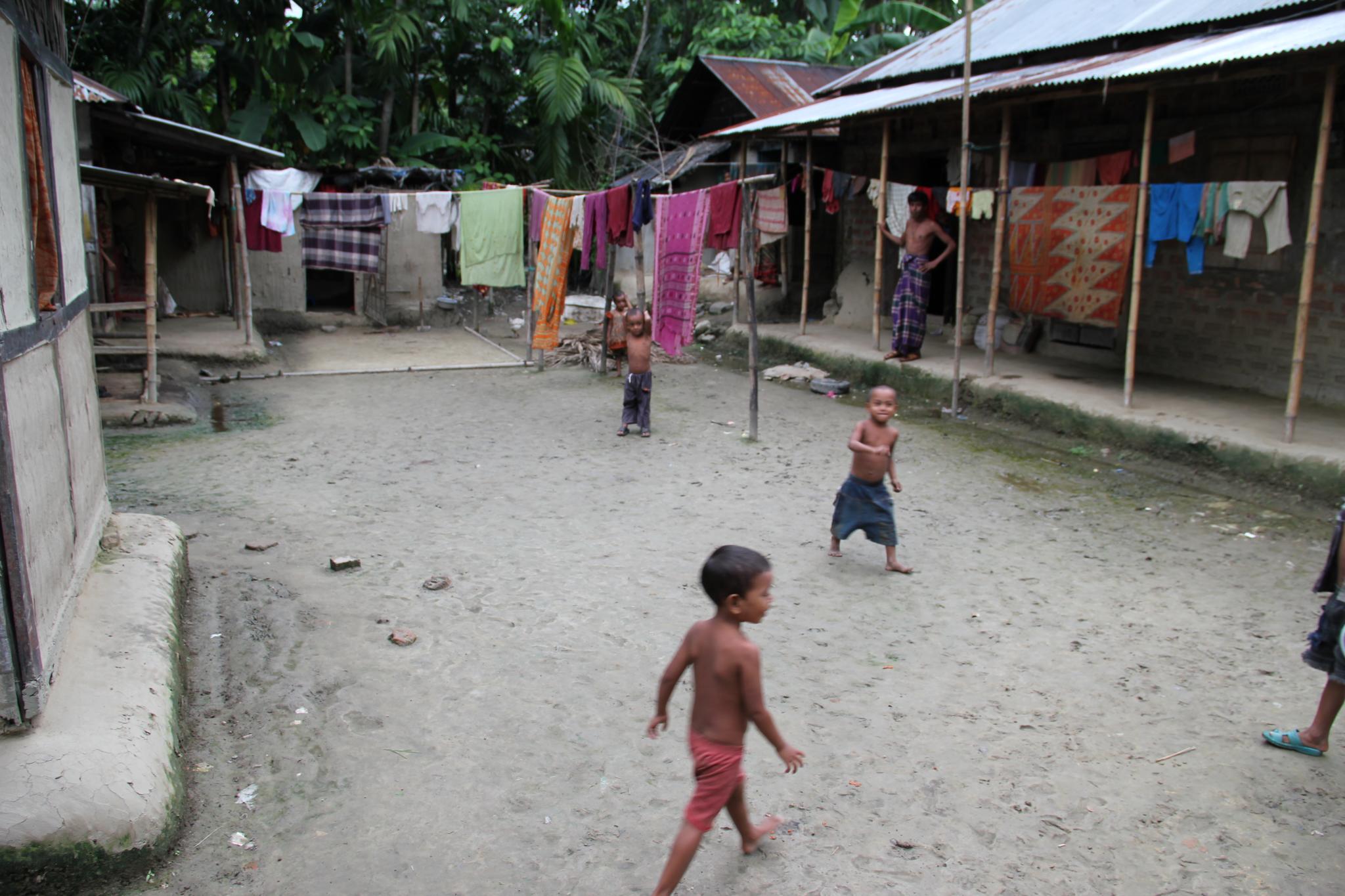 children are playing ball in an outside town