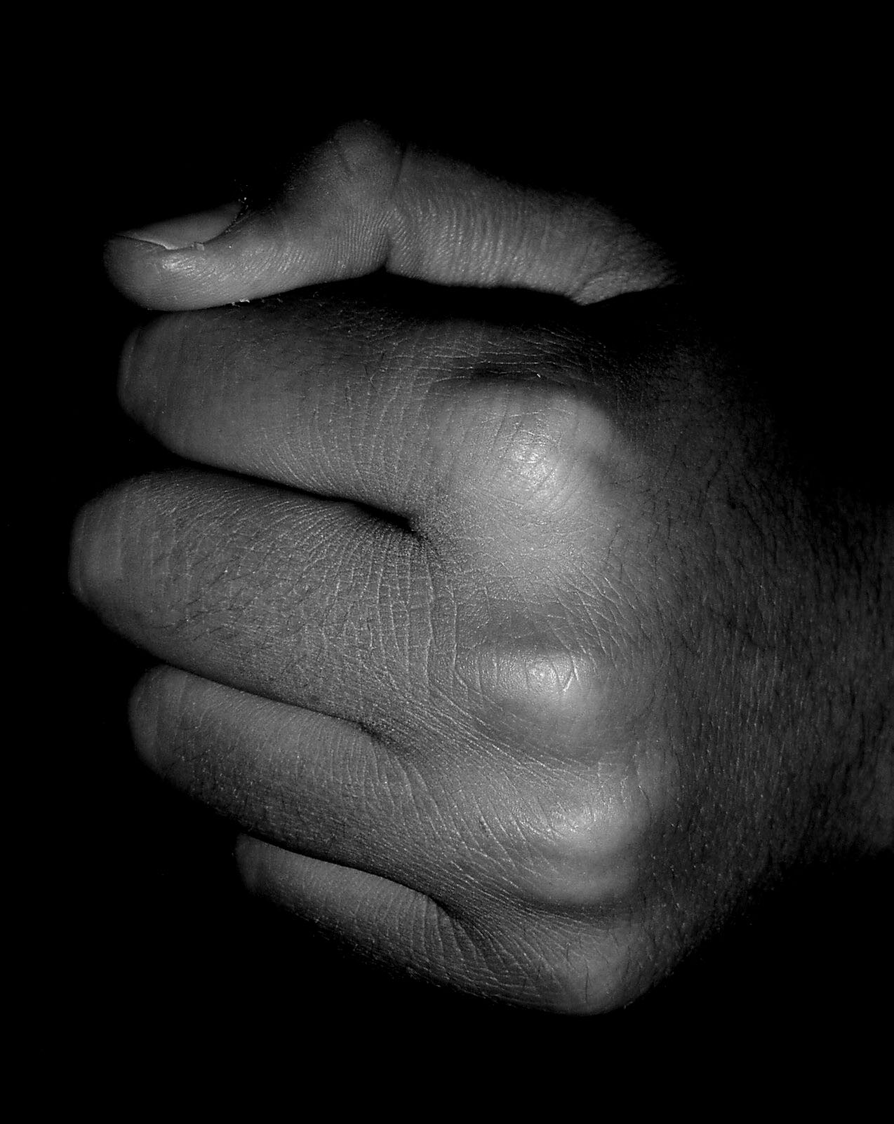 hands on a black background holding soing in their fingertips