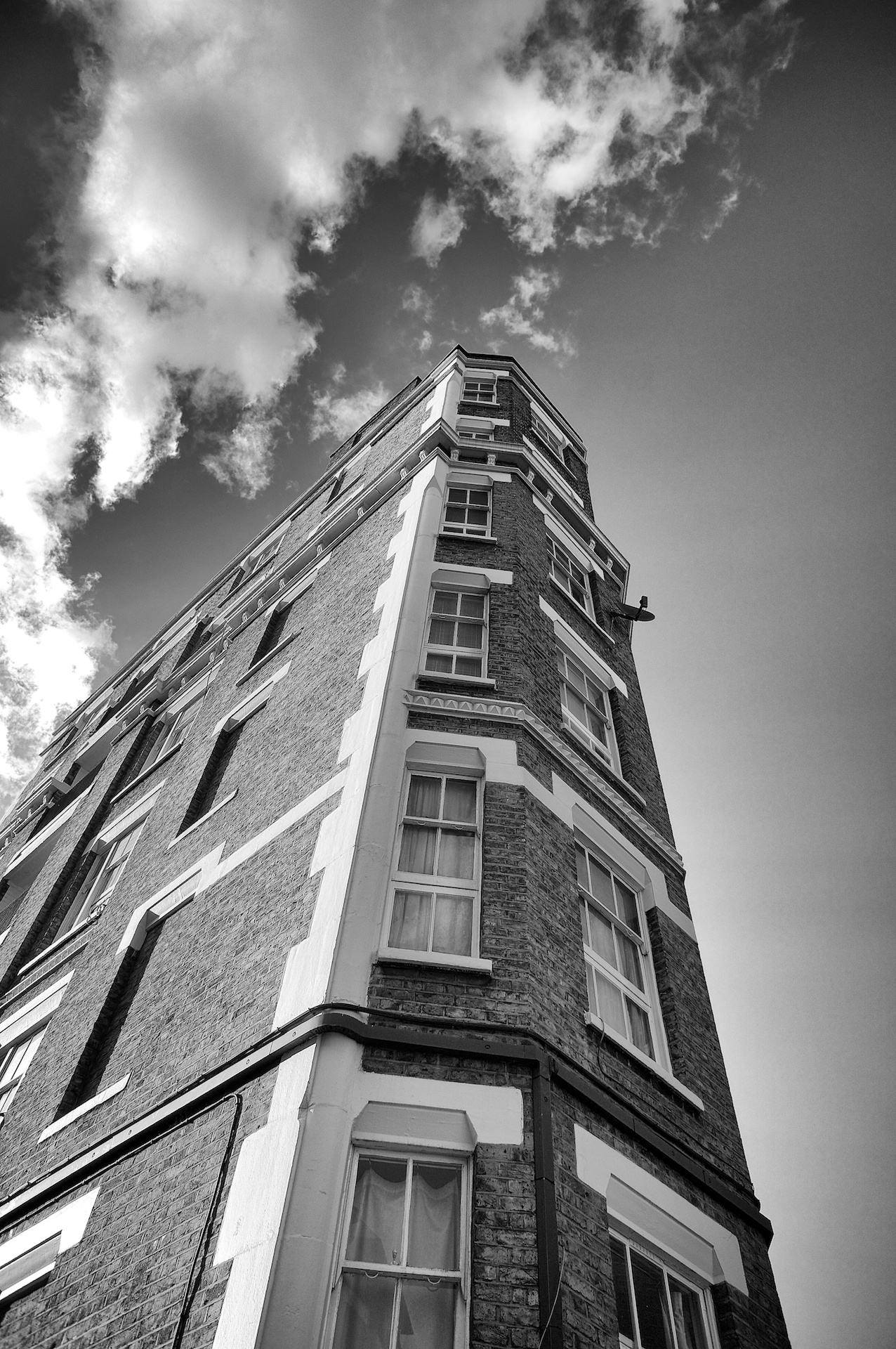 an upward black and white s of an old brick tower