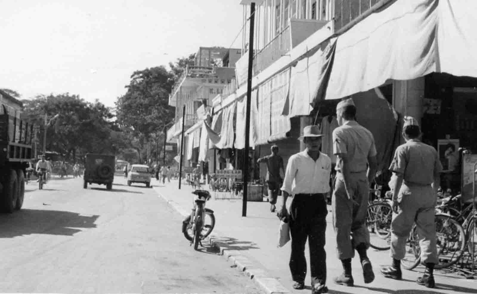 an old picture shows men walking down the street