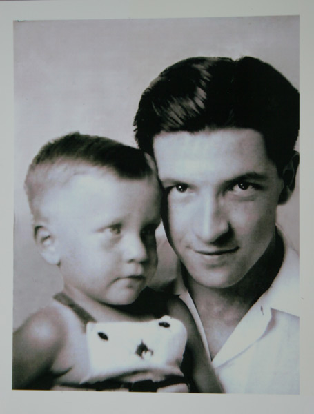 a black and white pograph of a man holding a child