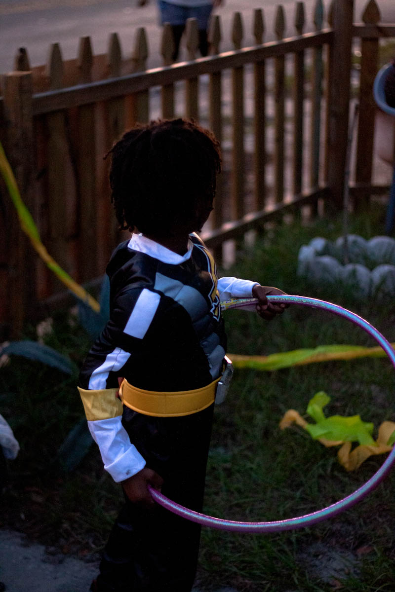 a little boy in a sailor suit playing with an oar