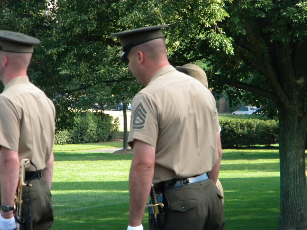 there are two officers that are standing in the grass