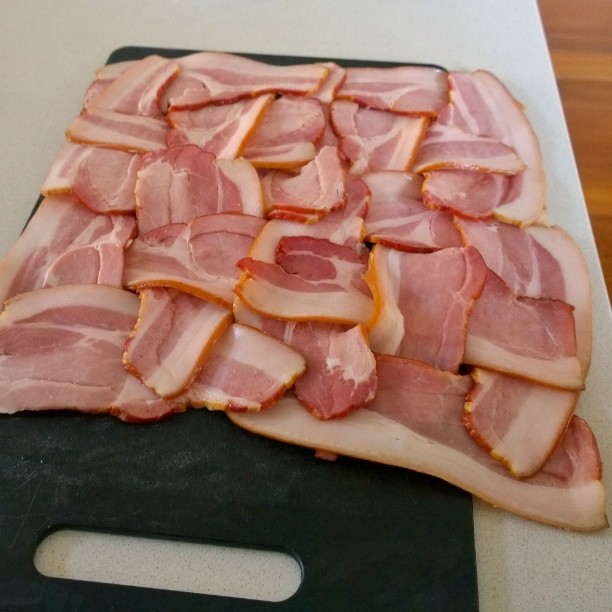 ham being cut into pieces on a  board