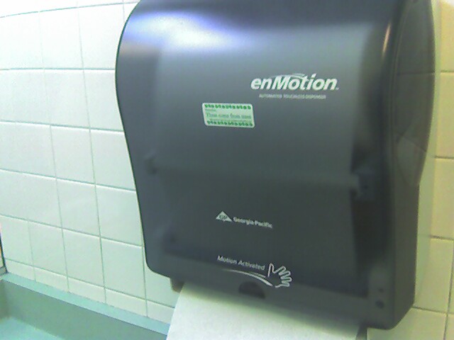 a black urinal in a public restroom