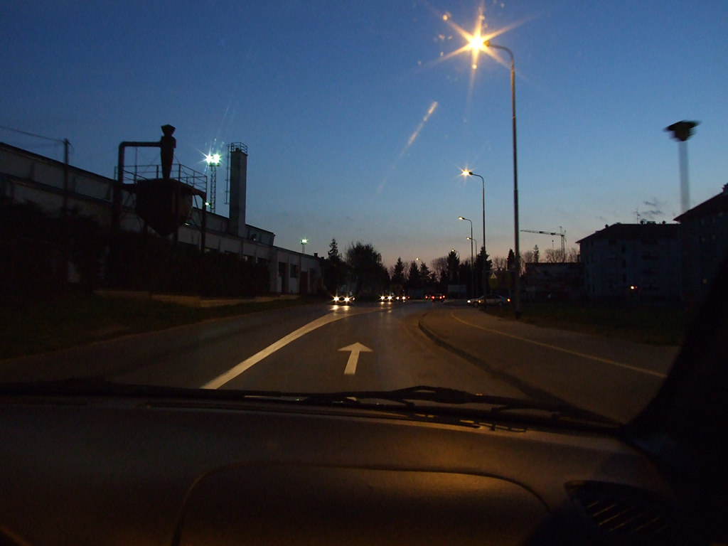 a po taken from inside the car, of the rear view mirror and streetlights