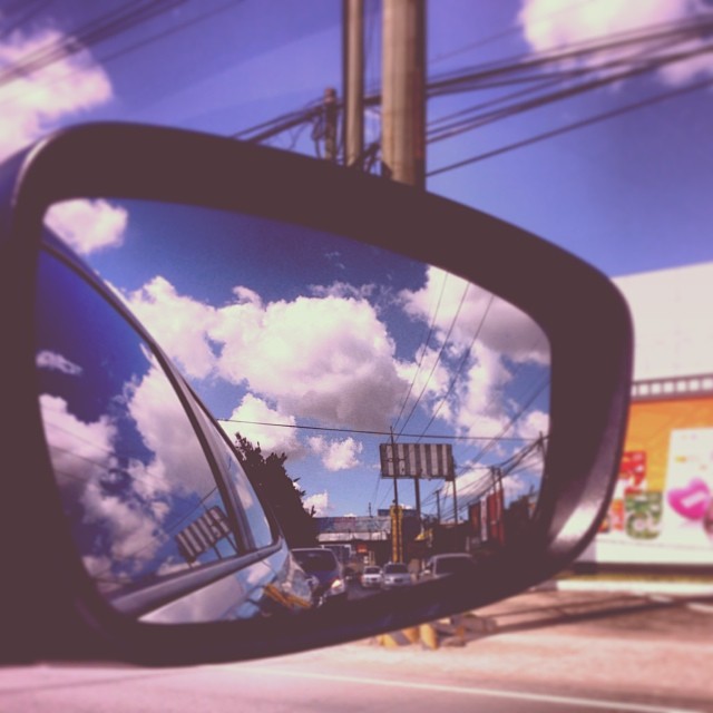 there is a side view mirror of an automobile