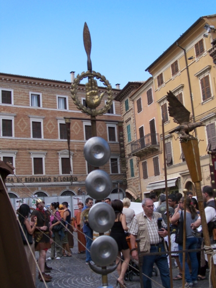a group of people stand around a sculpture made out of metal