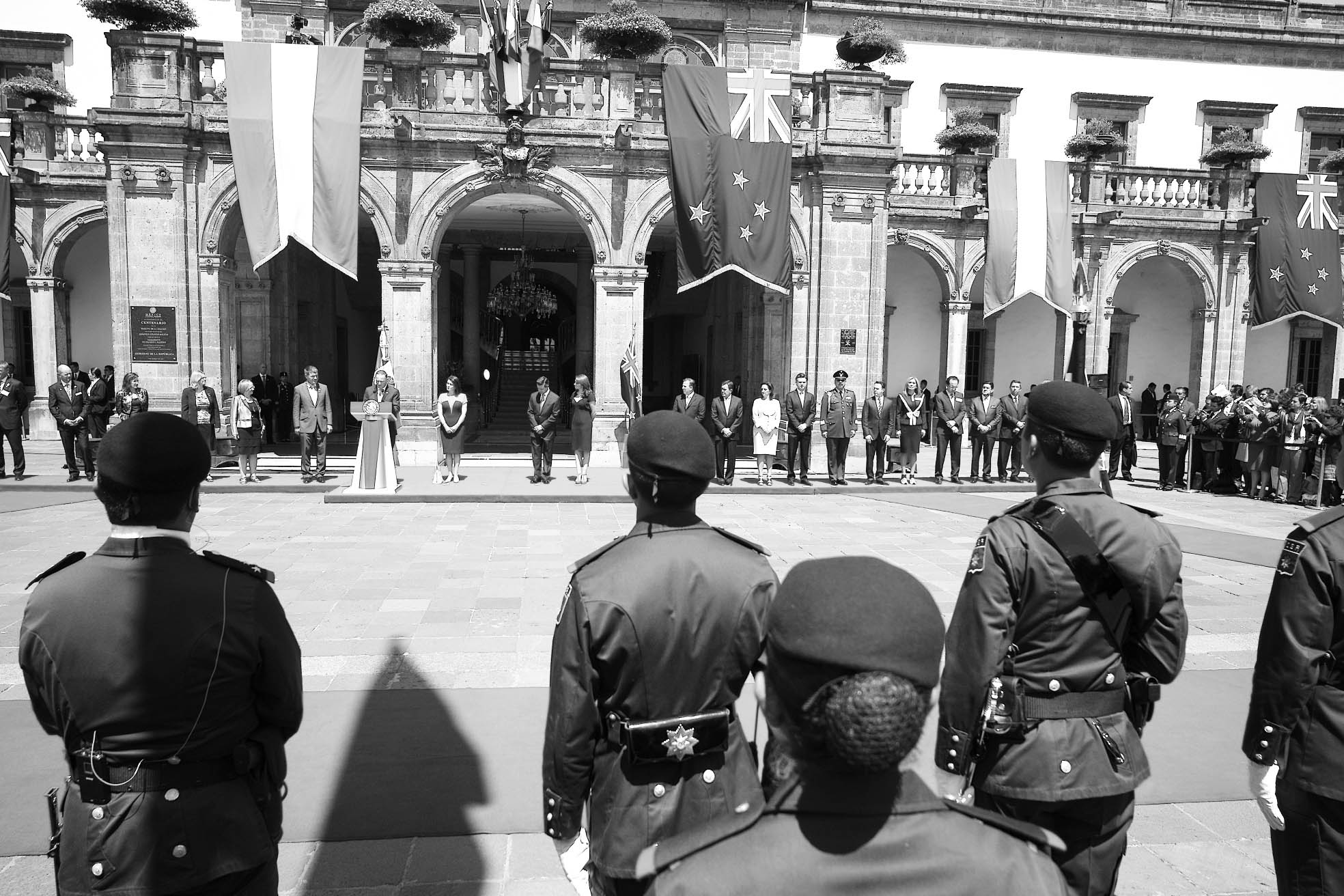 a group of uniformed soldiers standing in front of a building