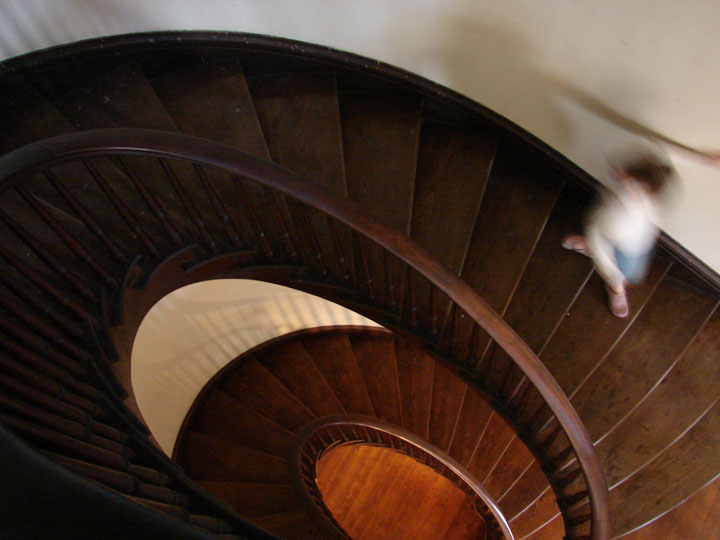 two people going down a wooden stair case