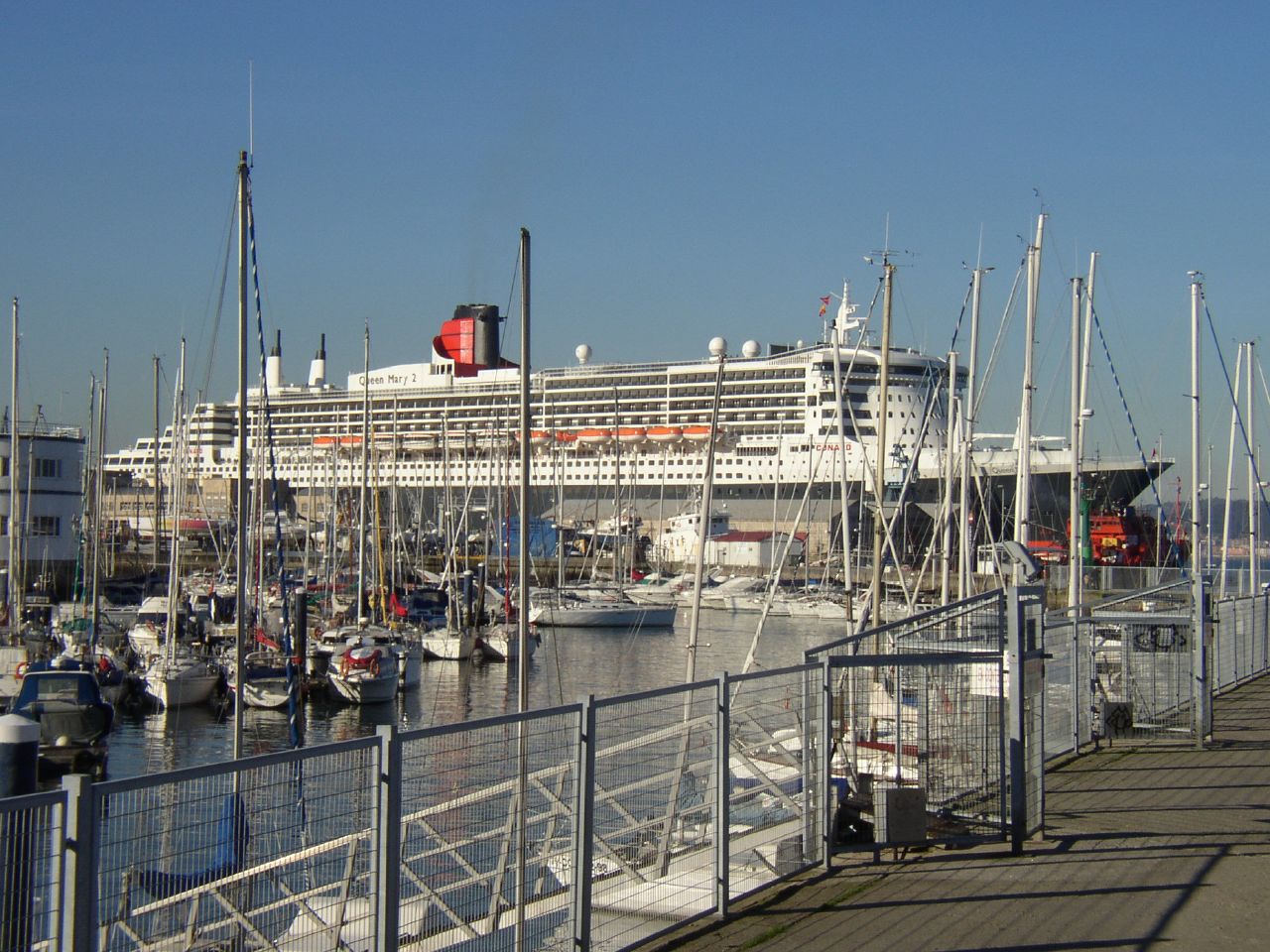 a white and black cruise ship docked at a pier