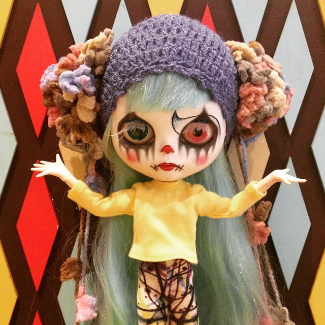 a creepy doll with white and blue hair