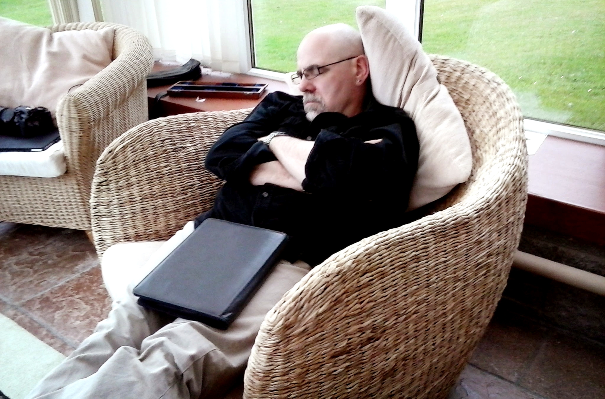 a man sitting in a chair with a laptop computer
