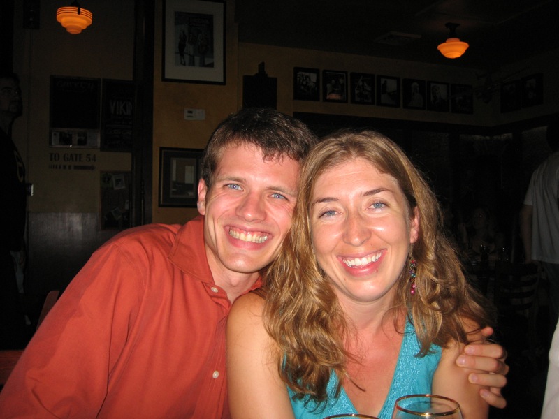 a couple smiling while sitting at a table