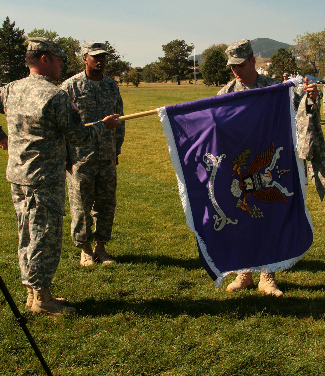 some soldiers standing in a field with a flag