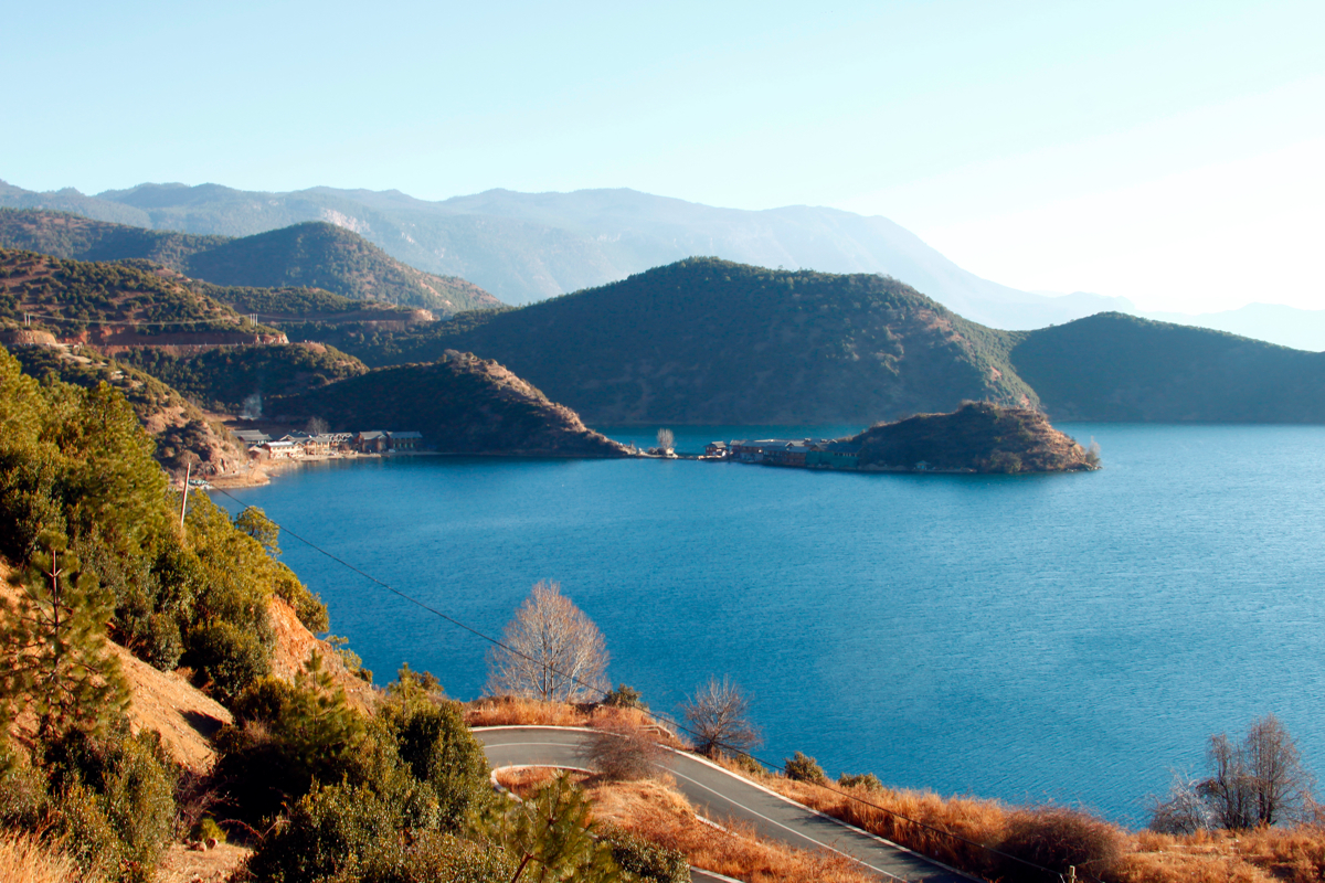 a large body of water surrounded by trees and hills