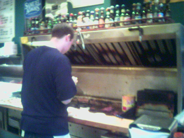 a man is waiting at a counter in a bar