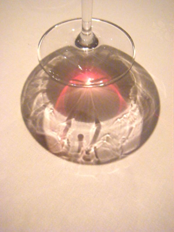a red wine glass sits empty on a table