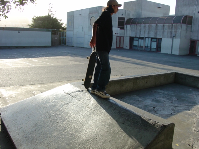 a person skateboards down a cement bench in front of some buildings